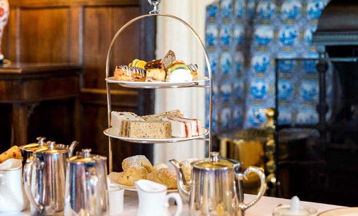 Afternoon Tea tower served with hot tea in front of the drawing room fireplace